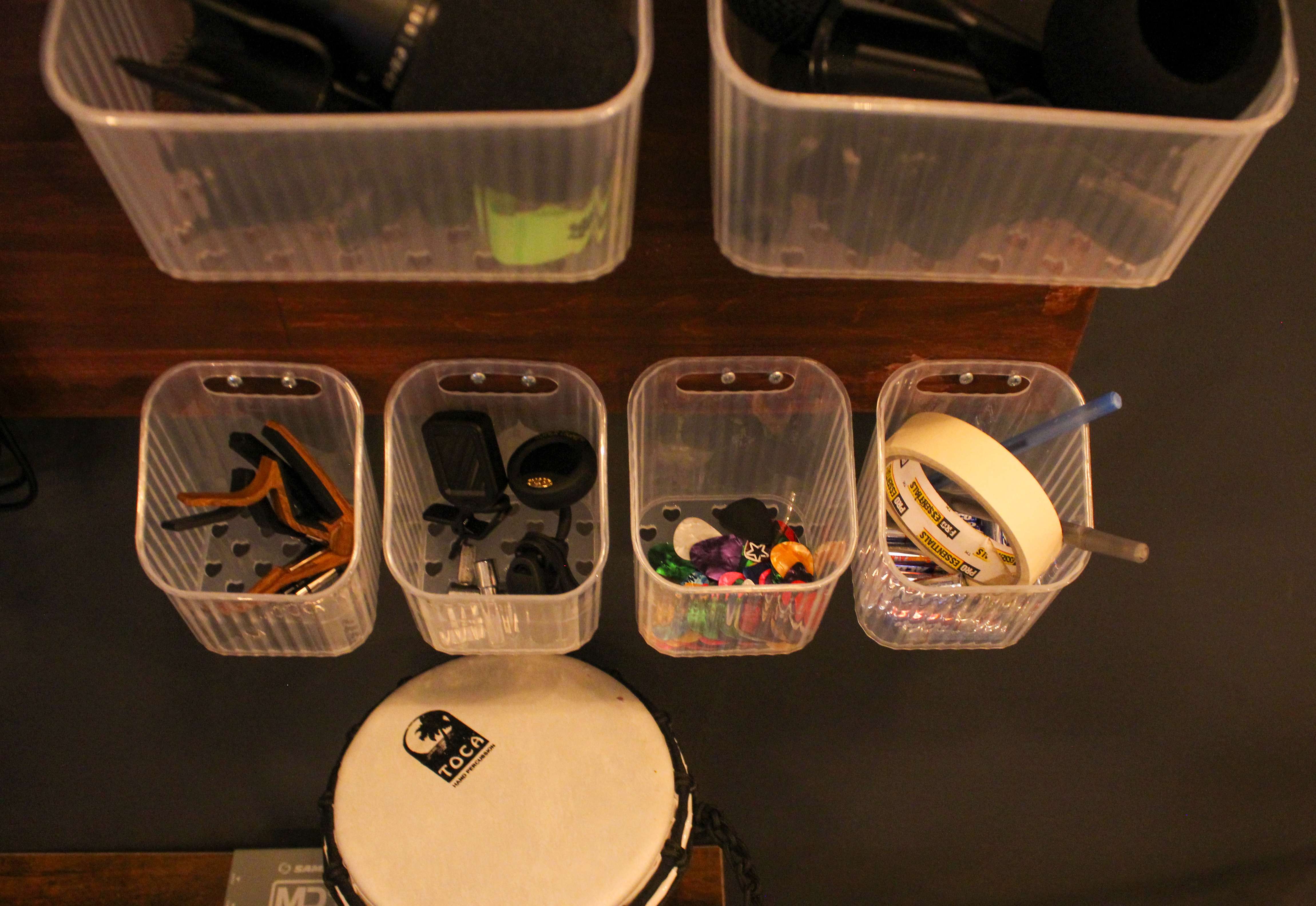 Bins of spare picks, capos, tuners, and tape stocked for members