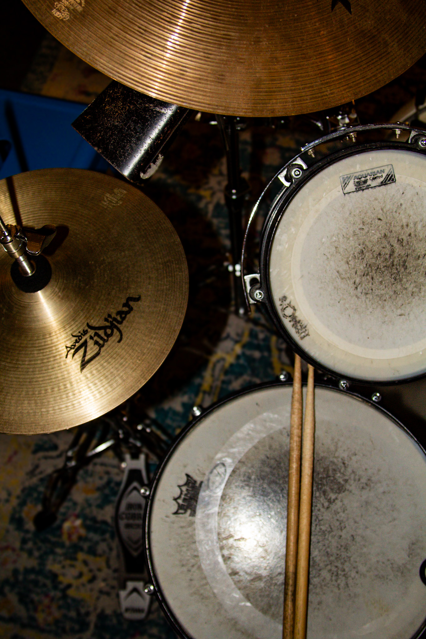 Zildjian cymbals, snare, and drumsticks in warm light, up close