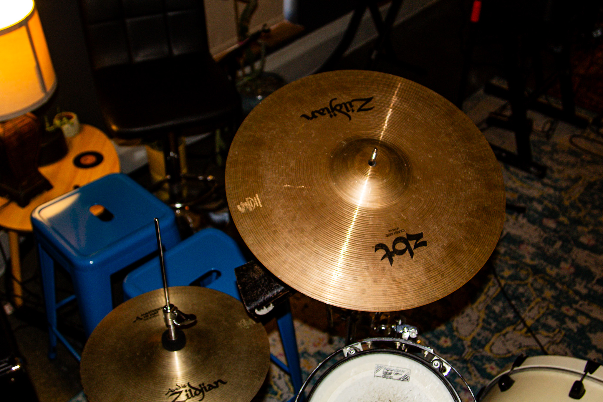 The house drum kit with Zildjian cymbals, shot from above on a patterned rug