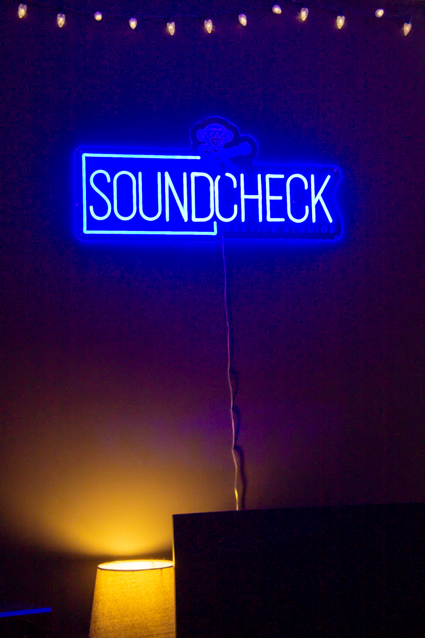 The recording room glowing under the blue Soundcheck neon sign